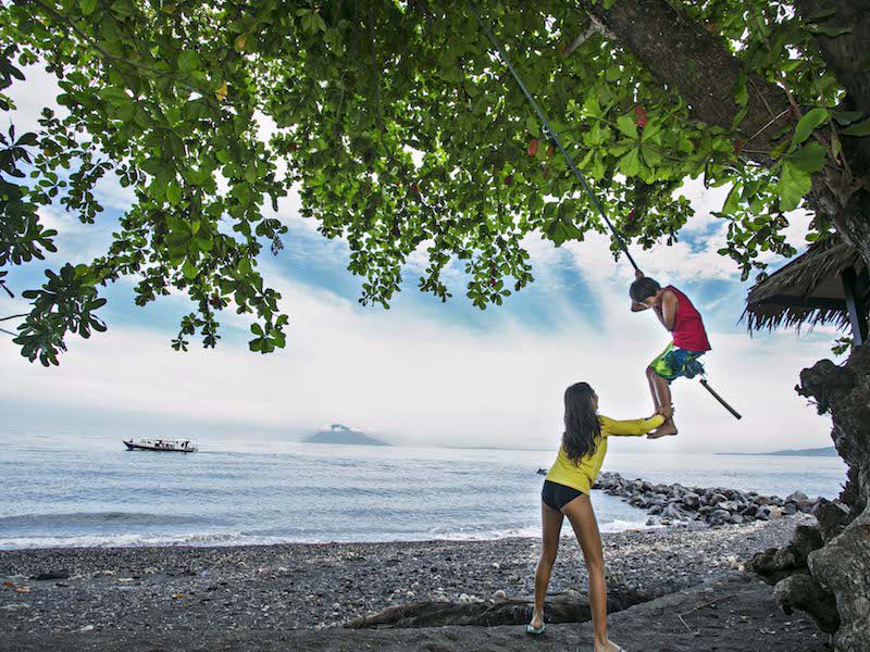 A kid playing swing at Murex Manado Playground