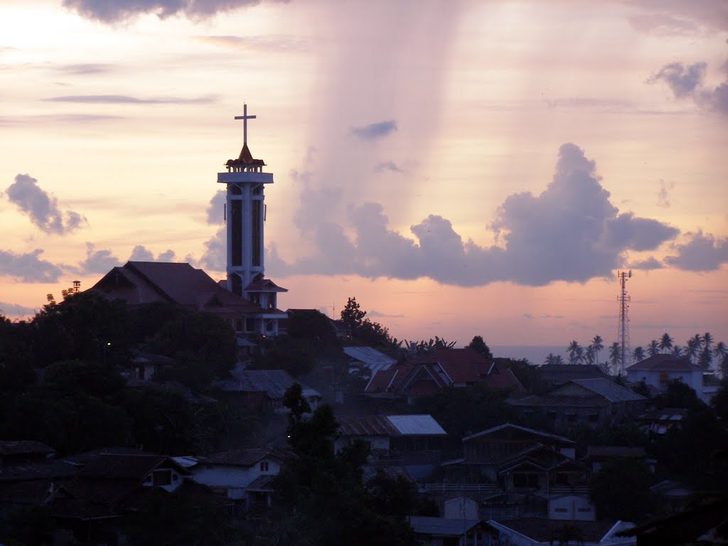 church tower and the manado skyline at sunset