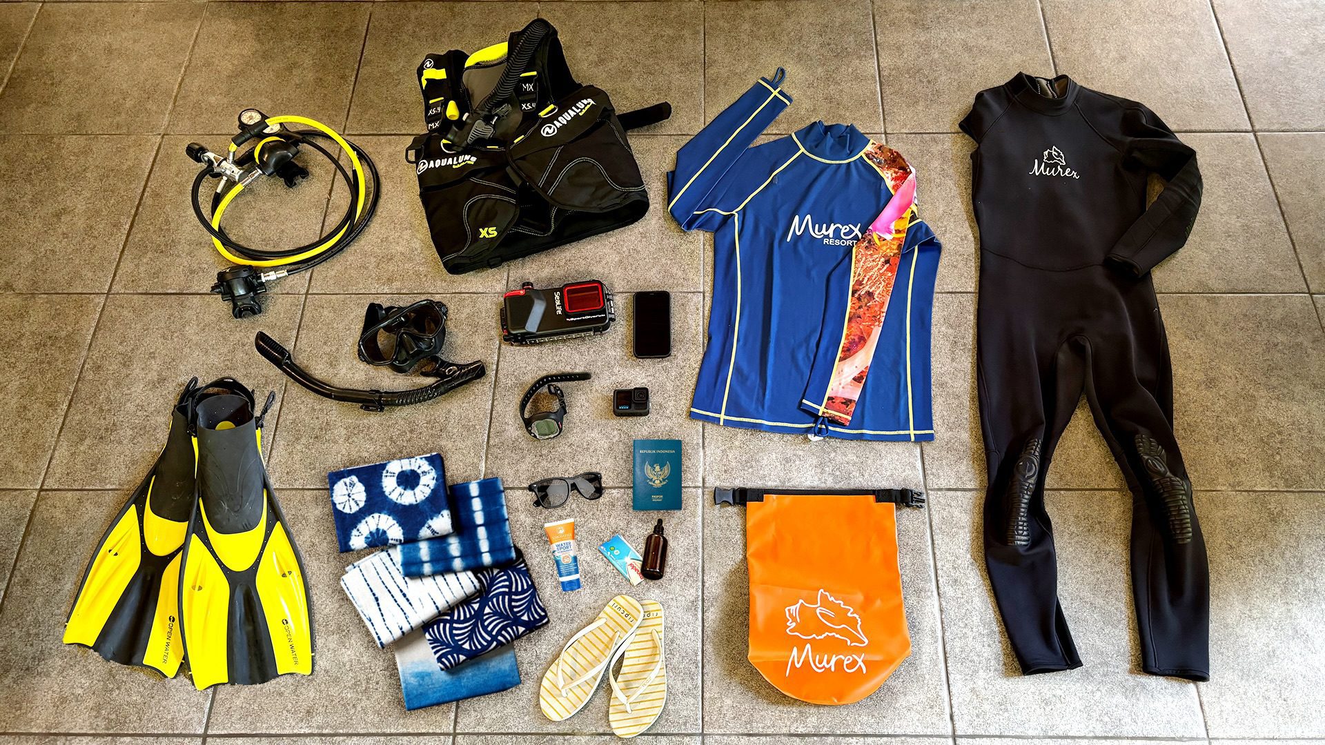 Packing List for Your Dive Trip: Regulator, BCD, Mask & Snorkel, Fins, Rashguard, Wetsuit (3-5mm), Underwater Camera Set, Drybag, Reef-safe Sunscreen, and other essentials.